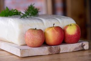a large fresh cheese with herbs and apples
