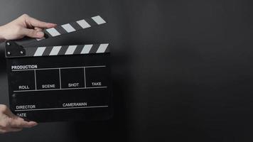 Movie clapperboard footage. Man hand holding film slate and clapping it in studio video