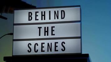 Behind the scene letters on cinema light box. Black text on white LED lightbox