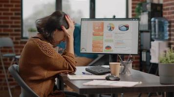 Frustrated woman trying to work on information rate charts video