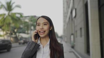 Businesswoman walking and talking on a smartphone