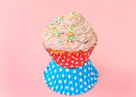 Cake with Cream, Cupcake on Pink Background. photo