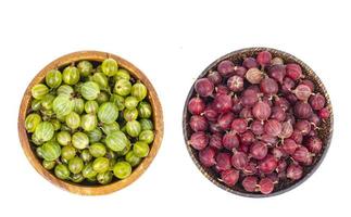 Organic berries, gooseberries in wooden bowl. Photo