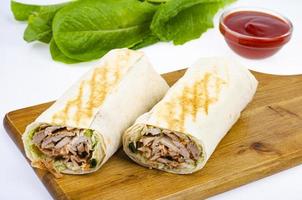 Shawarma, lavash with meat and vegetables. Photo