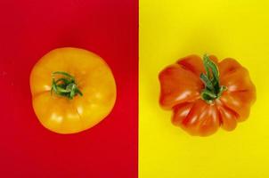 Bright background with tomatoes on red and yellow background. photo