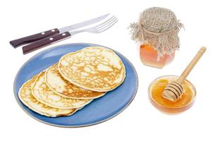 Delicious sweet thin pancakes on blue plate. photo