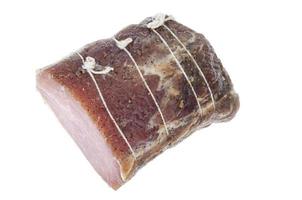 pedazo de carne de cerdo seca con especias sobre fondo blanco.