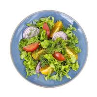 Vegetable dishes, fitness menu. Blue plate with salad on white background. photo