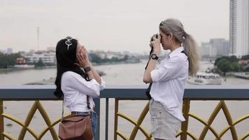 Two women taking pictures from each other. video