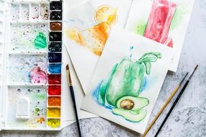 top view of handdrawn watercolor illustration and tools for drawing