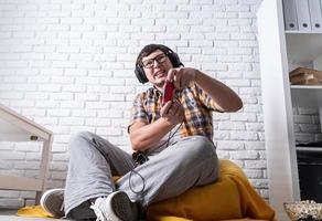 Young man playing video games at home photo