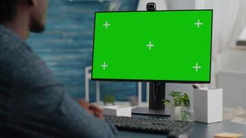 Close up of african american man talking on video call on computer with mock up chroma display