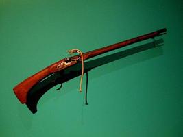 Old musket hanging on the wall photo