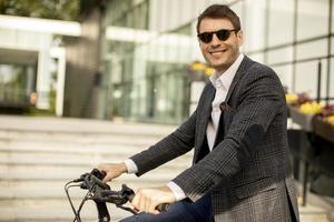 Young businessman on the ebike photo
