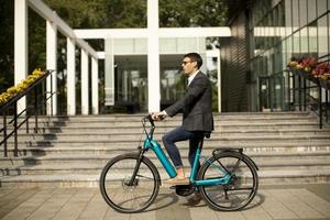 Young businessman on the ebike photo