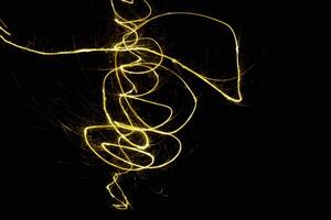 abstract circle gold light trail glowing spiral stylish light effect on a black. photo