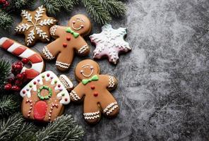 Homemade gingerbread cookies border with copy space on dark background photo