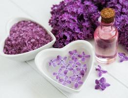 Essential oil with lilac flowers photo