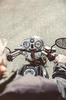 Senior man steering motorcycle on road photo