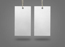 Two paper labels on grey surface photo