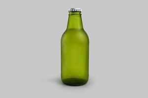 Cold green beer bottle isolated photo