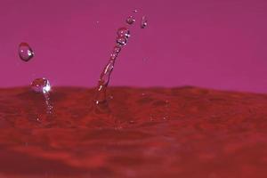 splash resulting from the impact of a drop with a container full of water photo