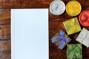 Christmas composition. Christmas gifts on wooden table. Top view, empty space, cardboard photo