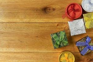 Christmas composition. Christmas gifts on wooden table. Top view, empty space, cardboard photo