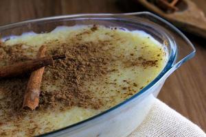 rice pudding with cinnamon on wooden table