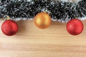 wooden background, christmas decoration with balls and gifts, decorative tree branches photo