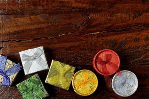 Christmas composition. Christmas gifts on wooden table. Top view, empty space, cardboard photo