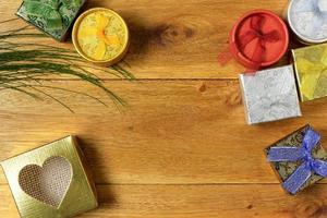 Christmas composition. Christmas gifts on wooden table. Top view, empty space, cardboard photo