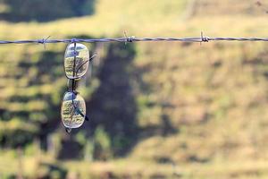 old glasses hanging from barbed wire, loneliness and abandonment of life photo