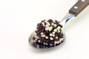 brigadeiro, brigadier, sweet chocolate typical of Brazilian cuisine covered with particles, in a wooden background. photo