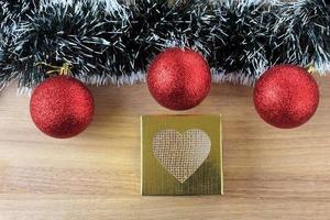 wooden background, christmas decoration with balls and gifts, decorative tree branches photo