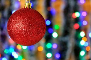 Red hanging ball, christmas decoration with blurred lights background. photo