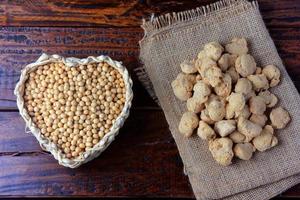 Soybean meat, chunks in a basket with heart shape. Raw soybeans chunks on rustic wooden background photo