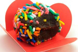 brigadeiro, brigadier, sweet chocolate typical of Brazilian cuisine covered with particles, in a wooden background. photo