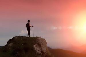 Woman in the mountains alone in a fiery sky photo