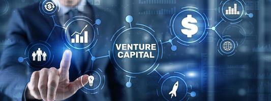 Venture capital. Investor capital. Businessman pressing virtual screen inscription photo