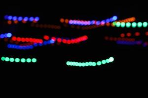 abstract circle line blue and green and orange urban realistic blurred glitter light colorful texture on black. photo