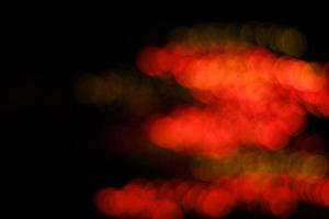 orange and yellow abstract urban realistic blurred glitter light colorful texture on black. photo