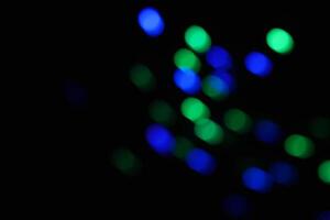 abstract green and blue urban realistic blurred glitter light colorful texture on black. photo