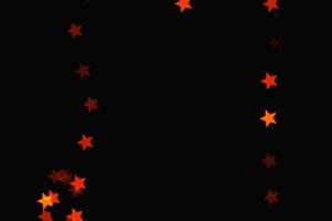 light orange star light effect isolated overlay glitter texture on black. photo