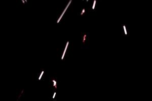 abstract lite red sparkler overlays elegant texture blur sparkling on black. photo