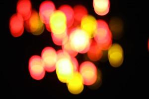 orange and yellow abstract urban realistic blurred glitter light colorful texture on black. photo