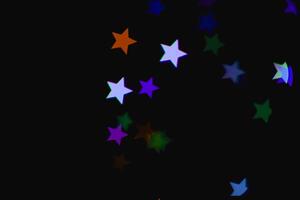 light colorful blue star light effect isolated overlay glitter texture on black. photo