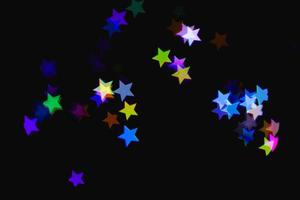 light colorful blue star light effect isolated overlay glitter texture on black. photo