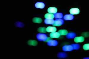 abstract green and blue urban realistic blurred glitter light colorful texture on black. photo