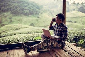 Freelancer male call checking job about creator or producer creative vlogger tourist in Tea 2000 farm at Chiang Mai Thailand